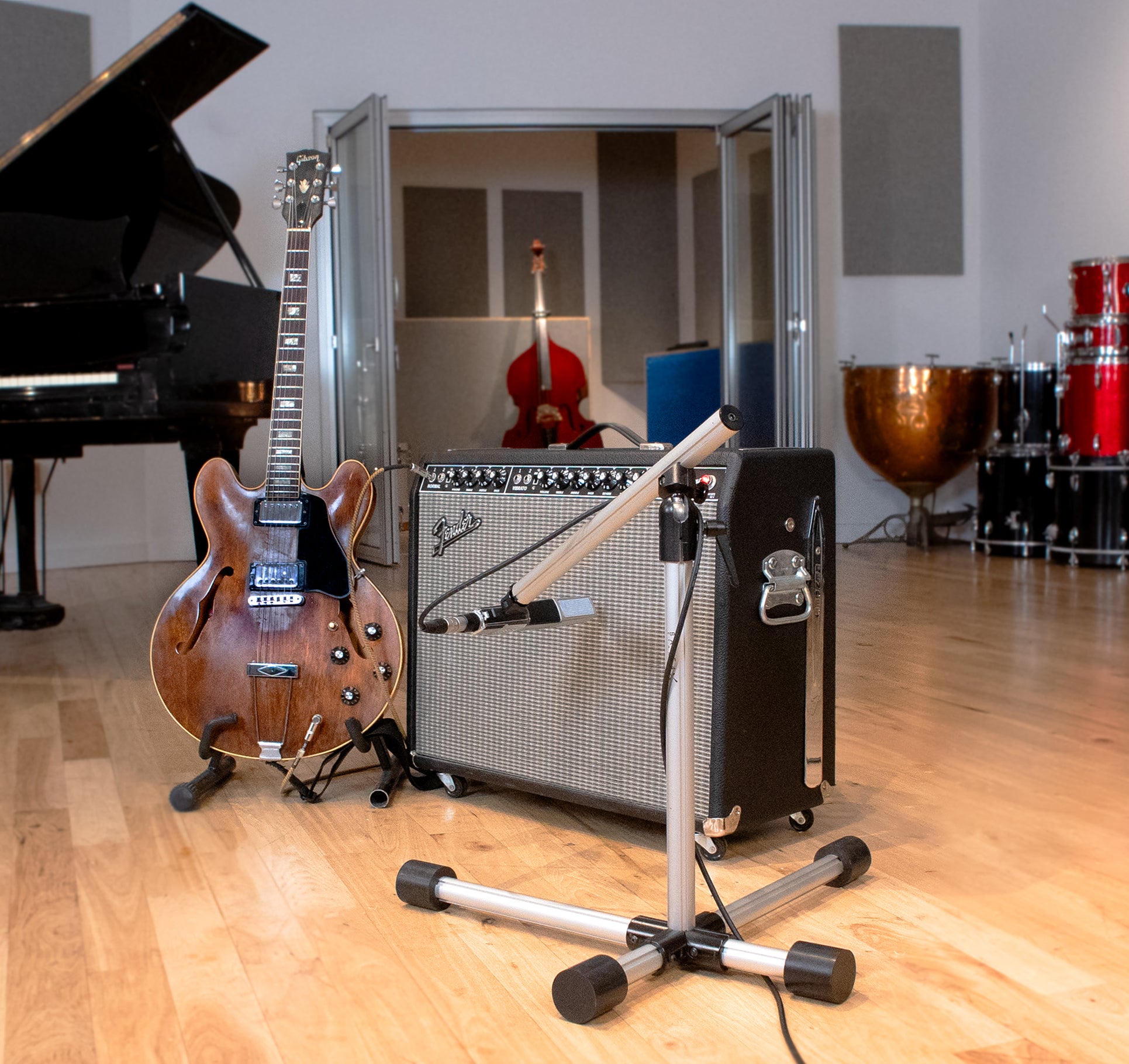 Base 4 Stands Shorty mic stand next to guitar amps
