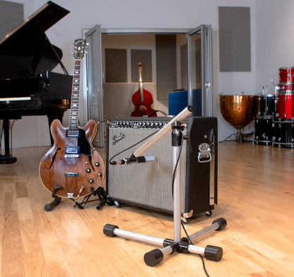 Base 4 Stands Shorty mic stand next to guitar amps